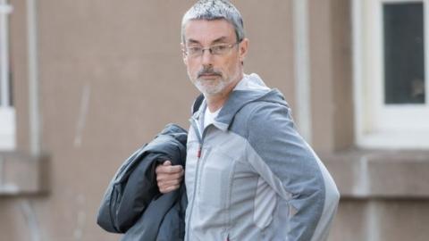 Simon Hayes arriving at Worcester Crown Court charged with perverting the course of justice by claiming not to know the identity of American pensioner Earl Roger Curry.