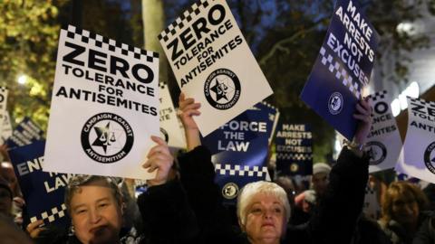 People holding placards at an anti-hate crime demonstration