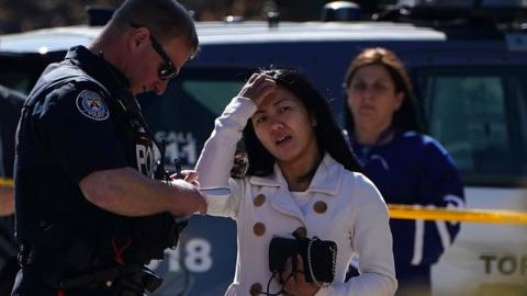 A witness speaks to a police officer at the scene of an incident where a van struck multiple people on Yonge Street in Toronto, Ontario, Canada April 23, 2018