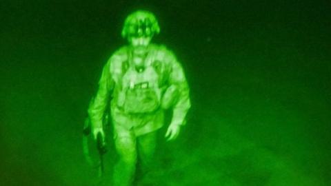 U.S. Army Major General Chris Donahue, commander of the 82nd Airborne Division, steps on board a C-17 transport plane