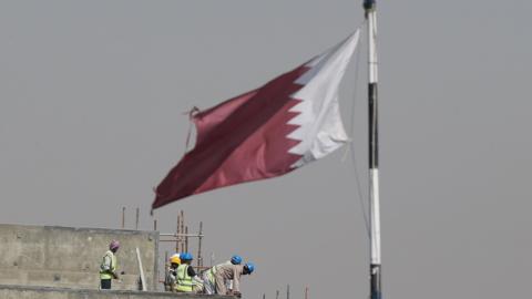 Construction workers are pictured on a building site on May 9, 2014 in Doha, Qatar