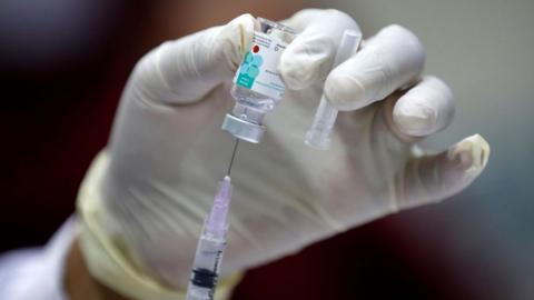 A health worker prepares a Human Papillomavirus (HPV) vaccine