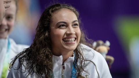 Grace Harvey celebrates her medal for England at the 2022 Commonwealth Games