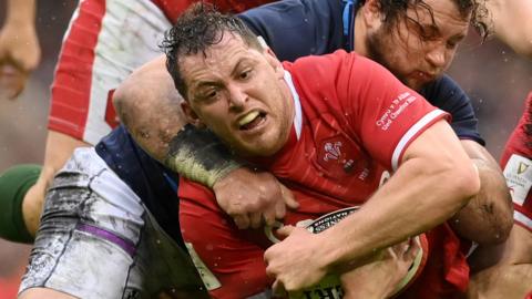 Ryan Elias of Wales is tackled by Scotland's Stuart McInally