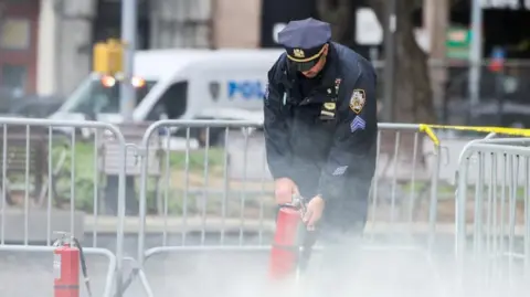 Policeman at the scene with a fire extinguisher