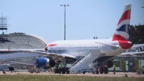 The side of a British Airways plane landing at Guernsey Airport.