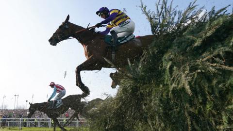 Corach Rambler jumping a fence at Aintree during the 2023 Grand National