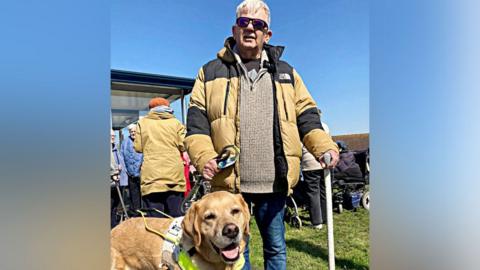 Stephen Hunt with his guide dog