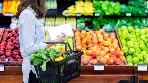 Woman buying vegetables and fruit