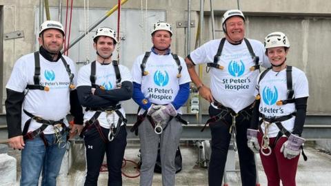 Abseilers wearing St Peter's Hospice t-shirts
