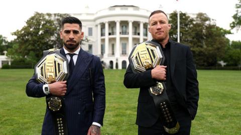 Illia Topuria (left) holds the UFC lightweight belt over his right shoulder and Justin Gaethje (right) has the UFC interim lightweight belt over his right shoulder