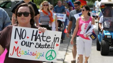 Protesters in St. Louis, Mississippi rally against a law they say discriminates against the LGBT community.