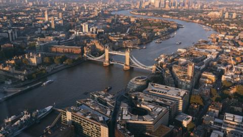 An aerial view of the centre of London in daytime with Tower Bridge in the foreground