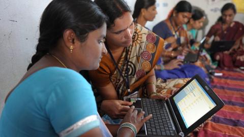 Indian women working on a laptop.