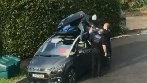 Police help Isa out of roofbox