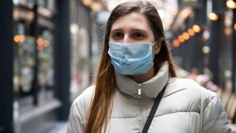 A woman wearing a face mask