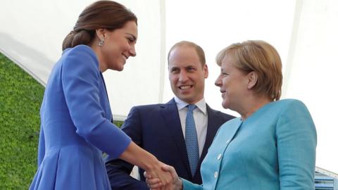 Duchess of Cambridge shakes Angela Merkel's hand, Prince William looking on (19 July)