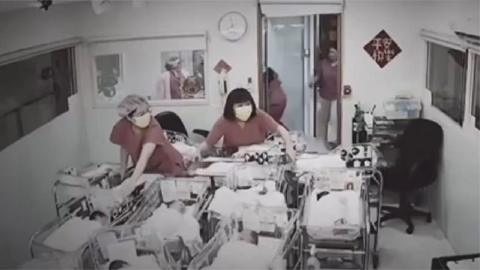 Nurses holding onto baby cots during the quake