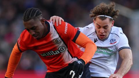 Luton Town's Amari'i Bell in action with Bolton Wanderers' Dion Charles in FA Cup third-round tie