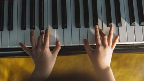 Hands playing the piano