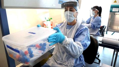 Live samples in test tubes are held in a container during the opening of the new Covid-19 testing lab at Queen Elizabeth University Hospital