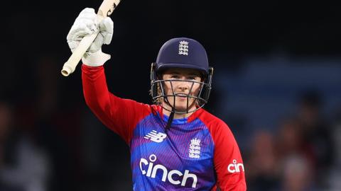 England batter Tammy Beaumont raises her bat in celebration after scoring a 50 against New Zealand in a T20 international