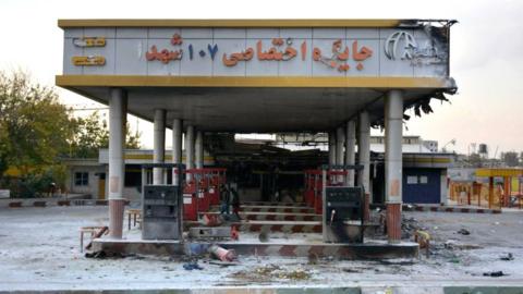 A burnt-out petrol station in Iran