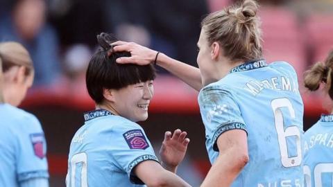 Aoba Fujino and Vivianne Miedema celebrate after Fujino scores the winning goal for Manchester City against Tottenham