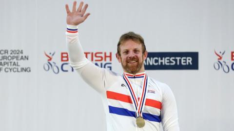 Jody Cundy waves on the podium wearing his national champion jersey