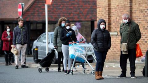 People queuing outside a supermarket in Streatham