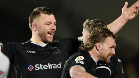 Callum Chick (left) - with his arms out - celebrates with Alex Hearle and Tom Gordon following Newcastle's win over Saracens 