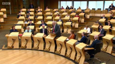 Mike Russell addressing MSPs