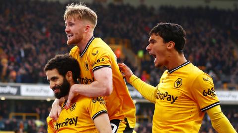 Rayan Ait-Nouri celebrates with Tommy Doyle and Nathan Fraser after scoring opening goal for Wolves against Fulham