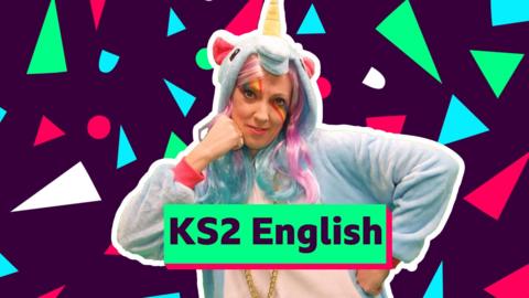A person in a unicorn costume in a dance pose - hands on hip and chin. Text reads 'KS2 English'. Background has red, green, blue and white shapes - circle and triangles - on a dark purple background.