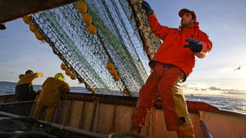 A fisherman on a trawler off the coast of Scotland