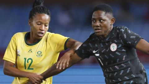South Africa forward Jermaine Seoposenwe fights for the ball with Nigeria defender Chidinma Okeke