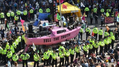 Officers surround the pink boat at Oxford Circus