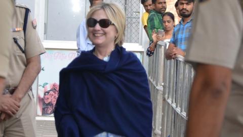 Photo taken on March 15, 2018 shows former US secretary of state Hillary Clinton, with her right hand covered under a shawl, at the airport as she leaves Jodhpur