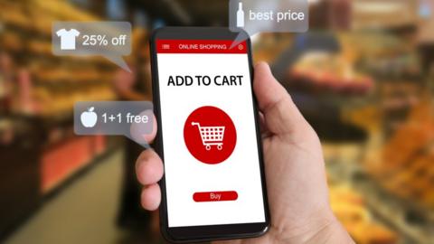Smartphone showing shopping basket in graphics