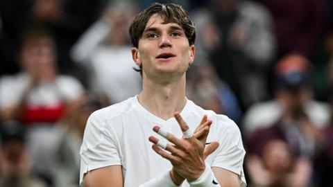 Jack Draper celebrates winning his first-round match at Wimbledon