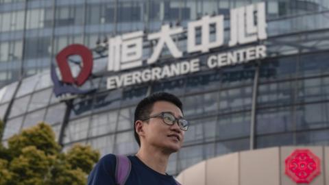A man walks past the Evergrande Center in Shanghai, China.