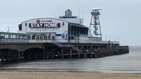 Bournemouth Pier sign says stay home