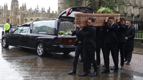 Jack Merritt's coffin being carried into church