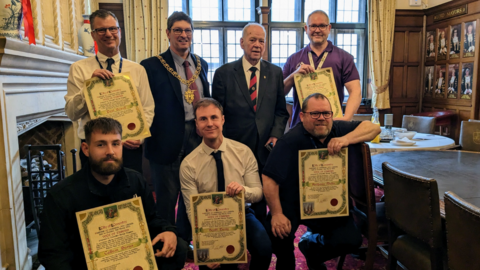 Council staff posing with certificates