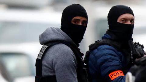 French special police forces are seen wearing balaclavas and protective clothing during a police operation in the Neudorf district of Strasbourg, France, December 13, 2018
