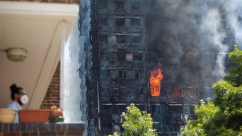 The fires continues to burn in Grenfell Tower fire, 12 hours after the fire broke out in the early hours of Wednesday 14 June
