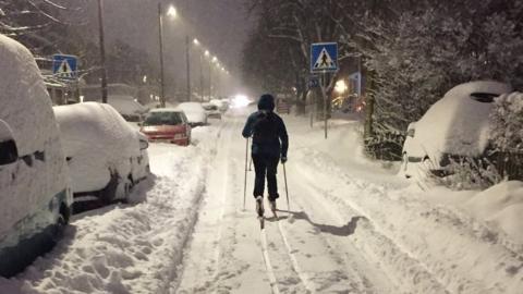 A person skiing in the street