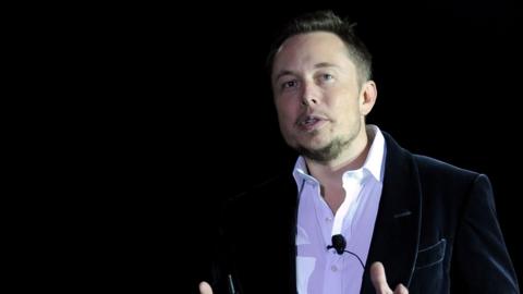 Elon Musk speaking on stage