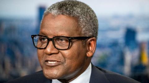 A close-up of Aliko Dangote as he gives a television interview in New York, US, on 23 September 2024. He is wearing glasses and has short, grey hair