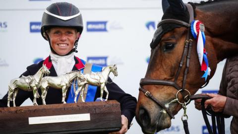 British rider Ros Canter celebrates with the Badminton Horse Trials trophy after winning on her horse Lordships Graffalo